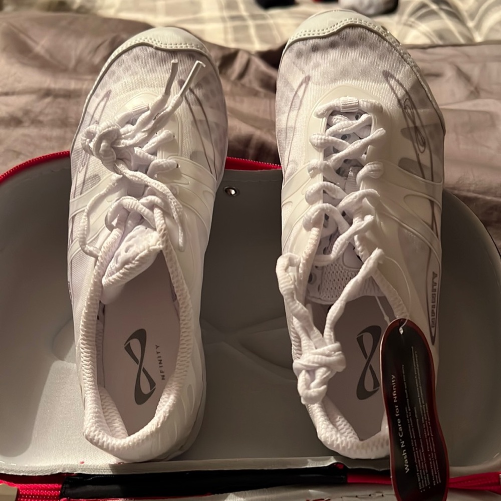 NFINITY white athletic shoes.